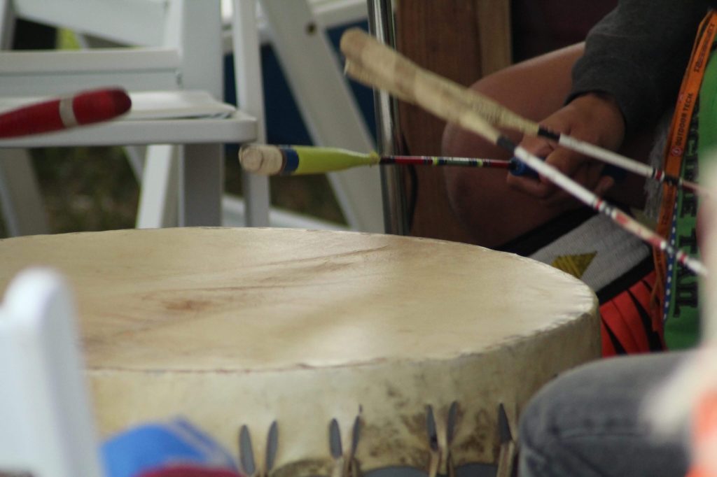 Native American singers keep rhythm while they sing